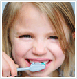 Image of child brushing teeth